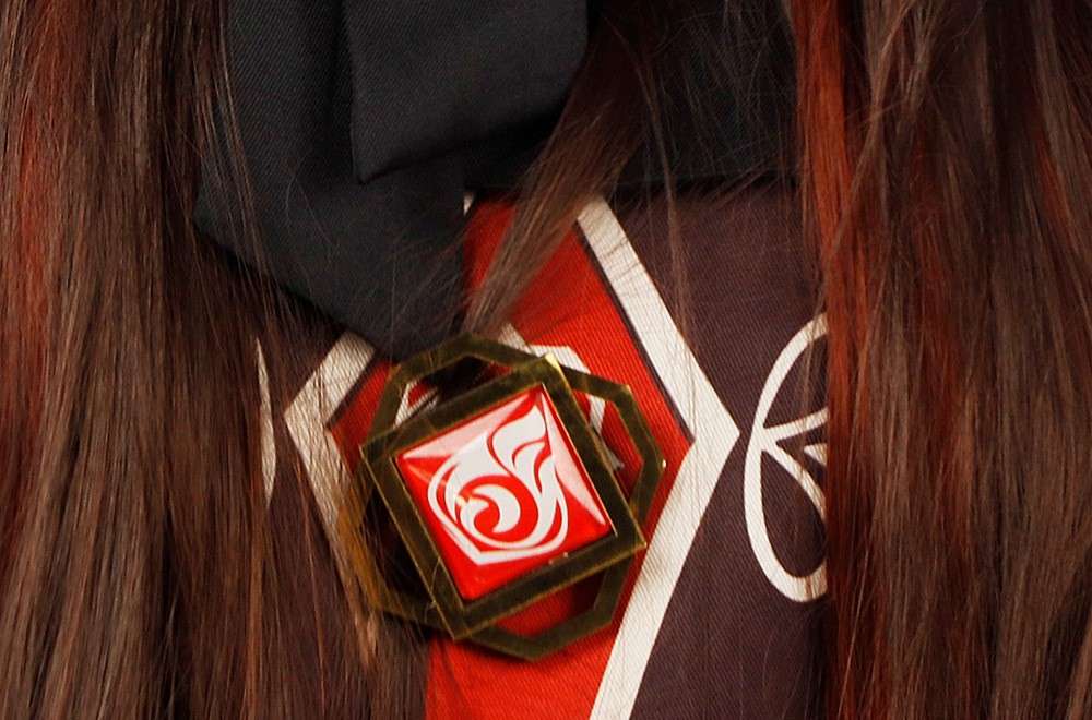 Close-up view of the embroidery and fabric details of the Hu Tao cosplay costume from Genshin Impact. 