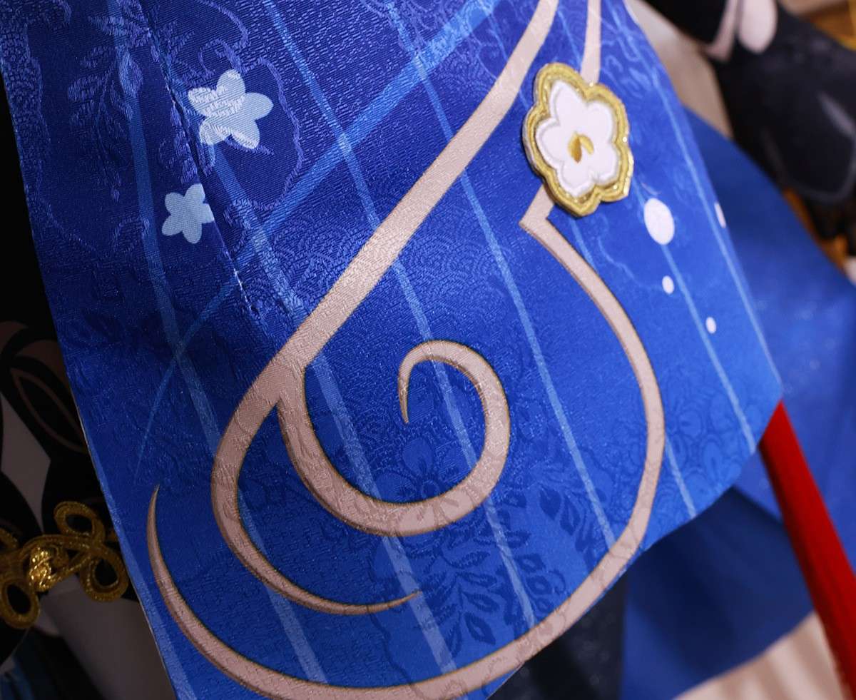 Close-up of Ganyu costume accessories like brooch and gloves