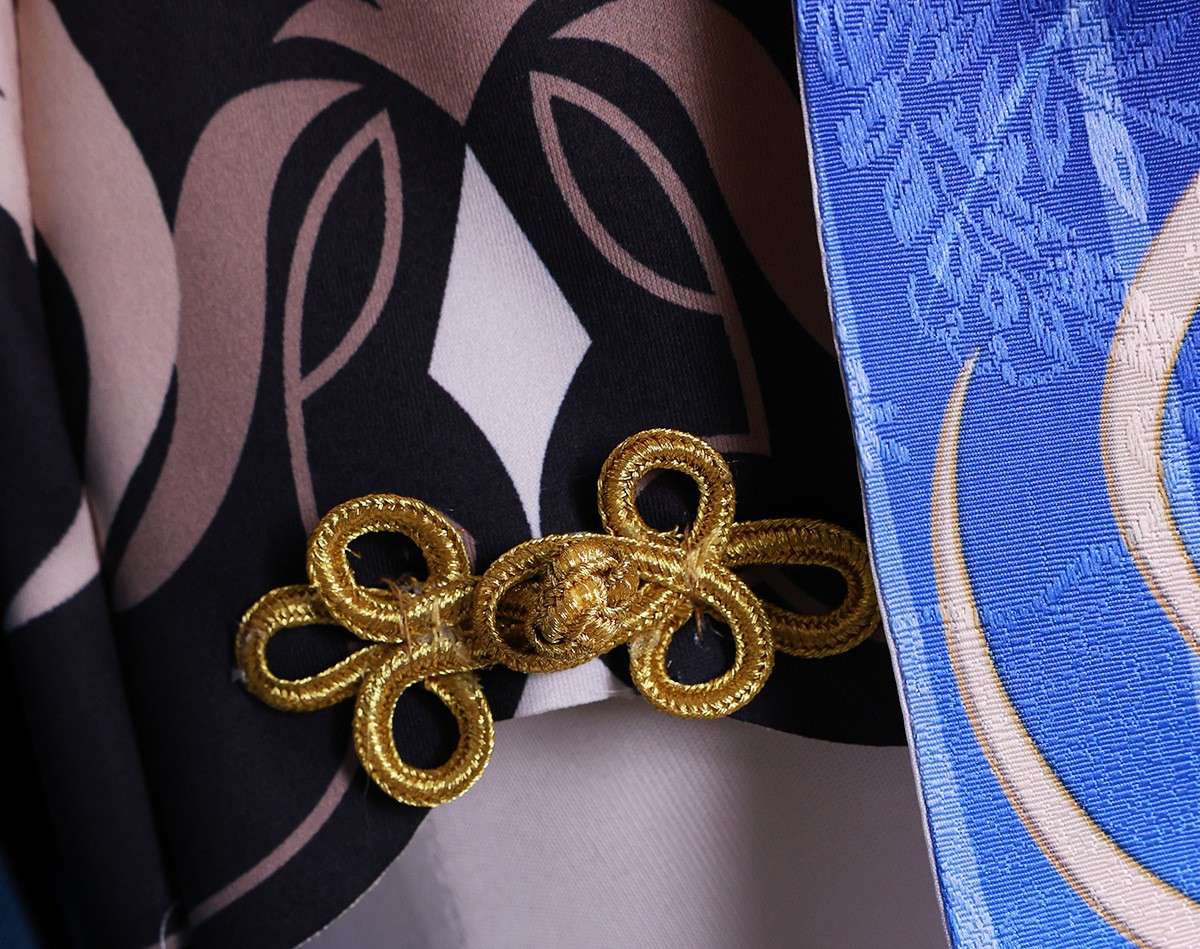 Close-up of Ganyu costume accessories like brooch and gloves