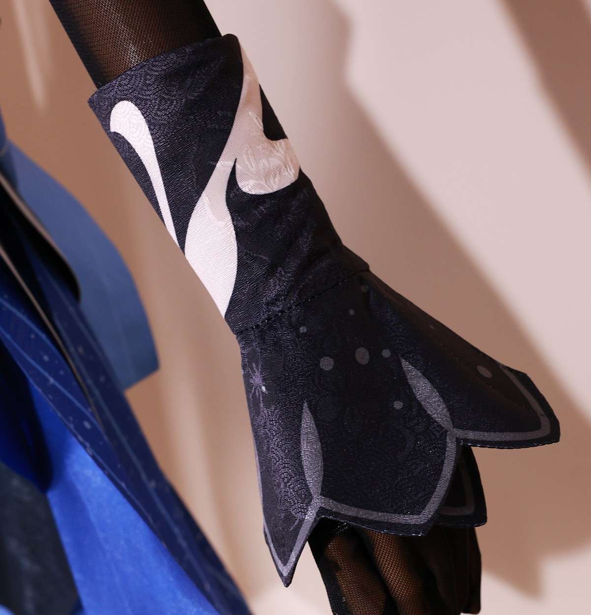 Close-up of Ganyu costume accessories like brooch and gloves