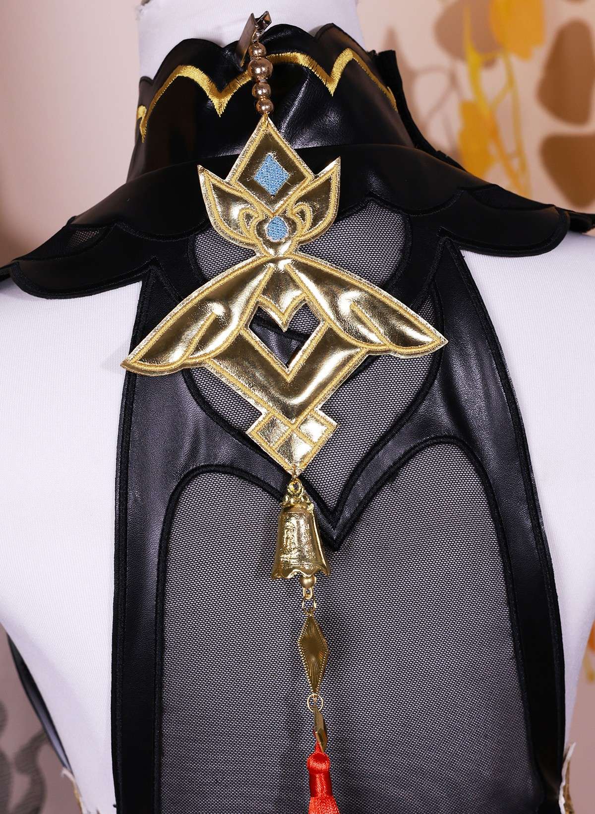 Close-up of Ganyu costume accessories like brooch and gloves