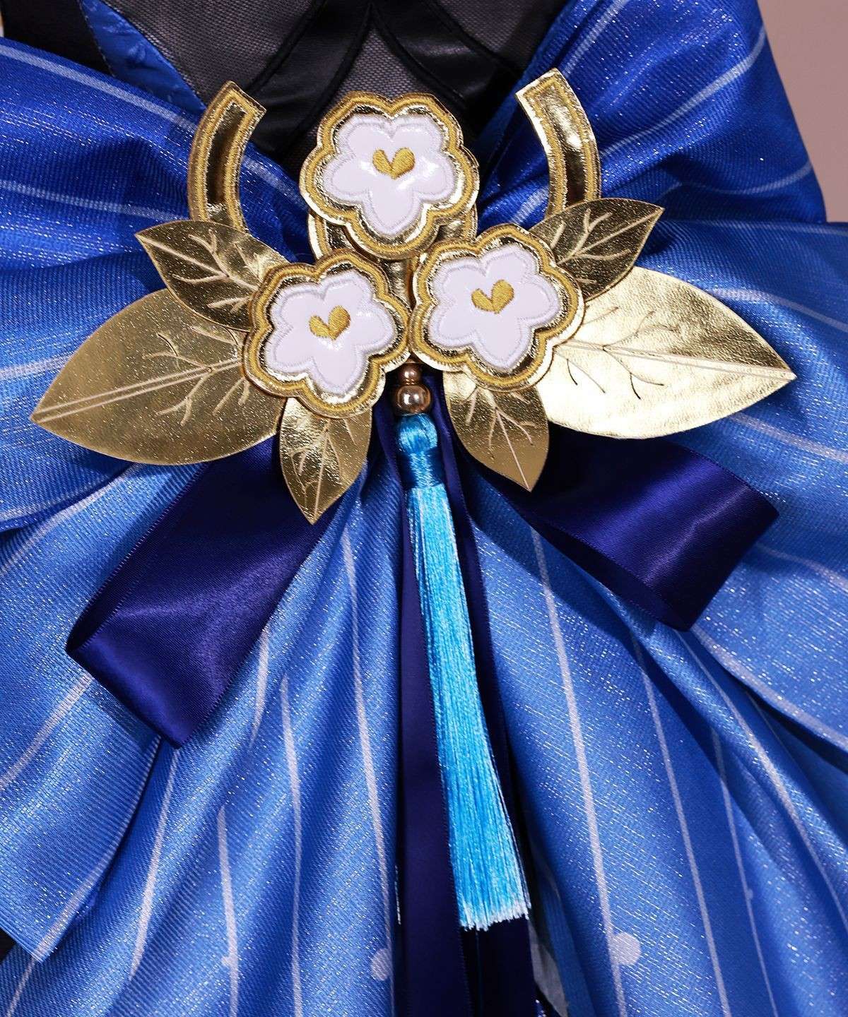 Close-up of Ganyu costume accessories like brooch and gloves
